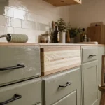 Rénover sa cuisine sans changer les meubles : façades vert sauge, crédence et poignées noires